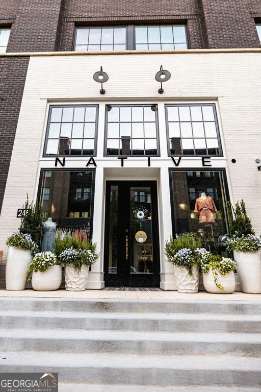 property entrance featuring brick siding