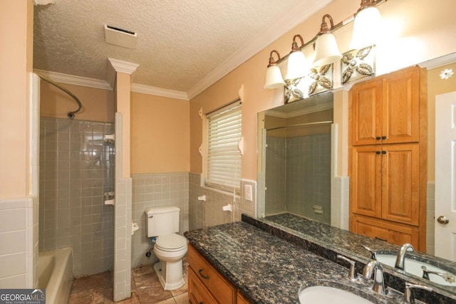 1100 Atlantic Ave, Waycross, GA 31501 - full bathroom featuring vanity, tile walls, a textured ceiling, ornamental molding, and a wainscoted wall