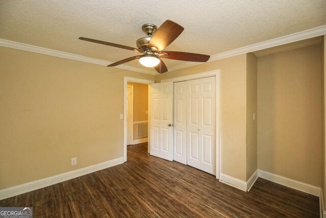 1100 Atlantic Ave, Waycross, GA 31501 - unfurnished bedroom with dark wood-style flooring, a closet, ornamental molding, a textured ceiling, and a ceiling fan