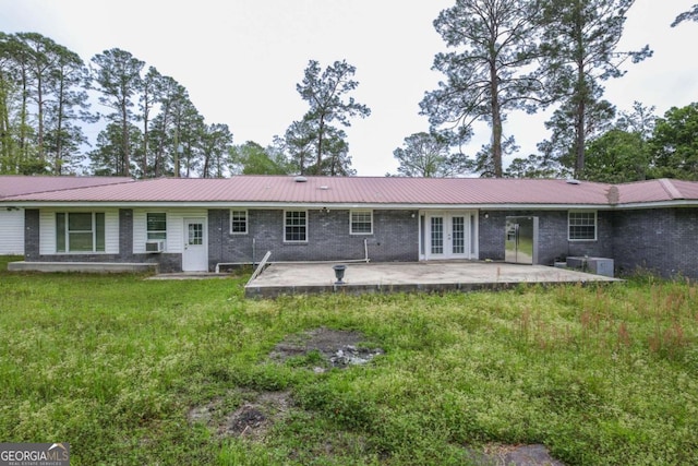 1100 Atlantic Ave, Waycross, GA 31501 - back of property with french doors, a patio area, a metal roof, and a lawn