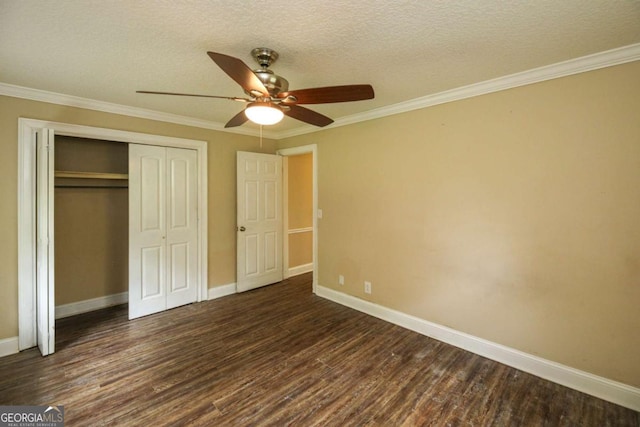 1100 Atlantic Ave, Waycross, GA 31501 - unfurnished bedroom featuring dark wood finished floors, a closet, crown molding, a ceiling fan, and a textured ceiling