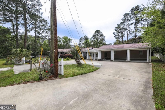 1100 Atlantic Ave, Waycross, GA 31501 - single story home featuring curved driveway, a metal roof, and an attached garage