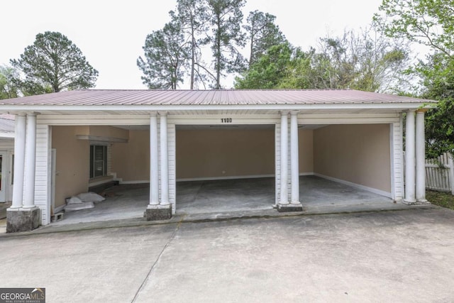 1100 Atlantic Ave, Waycross, GA 31501 - garage featuring concrete driveway and a carport