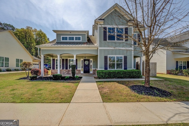 craftsman inspired home with metal roof, a front lawn, and covered porch