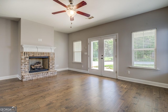 unfurnished living room with wood finished floors, baseboards, a ceiling fan, and visible vents