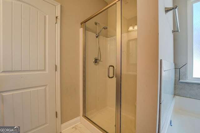 full bathroom with a shower stall and a garden tub