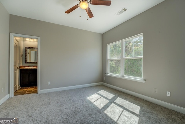 unfurnished bedroom featuring carpet floors, baseboards, and visible vents
