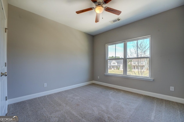 empty room featuring light colored carpet, baseboards, and visible vents