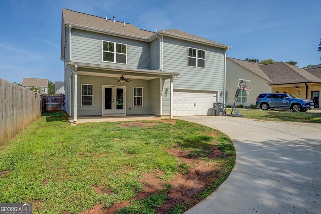 back of house with ceiling fan, a garage, fence, concrete driveway, and french doors