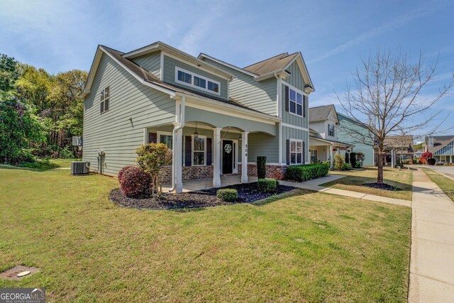 view of front facade featuring a front lawn, cooling unit, and covered porch