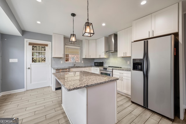 4329 Cedar Valley Ln, Conley, GA 30288 - kitchen with appliances with stainless steel finishes, wall chimney range hood, tasteful backsplash, white cabinets, and wood tiled floors