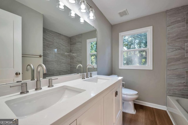 3650 Clovis Ct NW, Atlanta, GA 30331 - full bathroom with baseboards, a sink, toilet, and wood finished floors