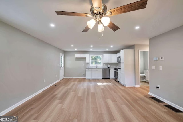 3650 Clovis Ct NW, Atlanta, GA 30331 - kitchen featuring white cabinets, stainless steel appliances, baseboards, and light wood-style floors