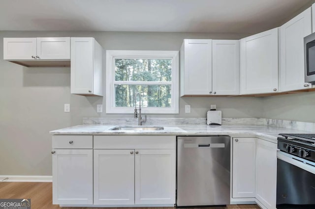3650 Clovis Ct NW, Atlanta, GA 30331 - kitchen with white cabinetry, a sink, light stone countertops, and appliances with stainless steel finishes