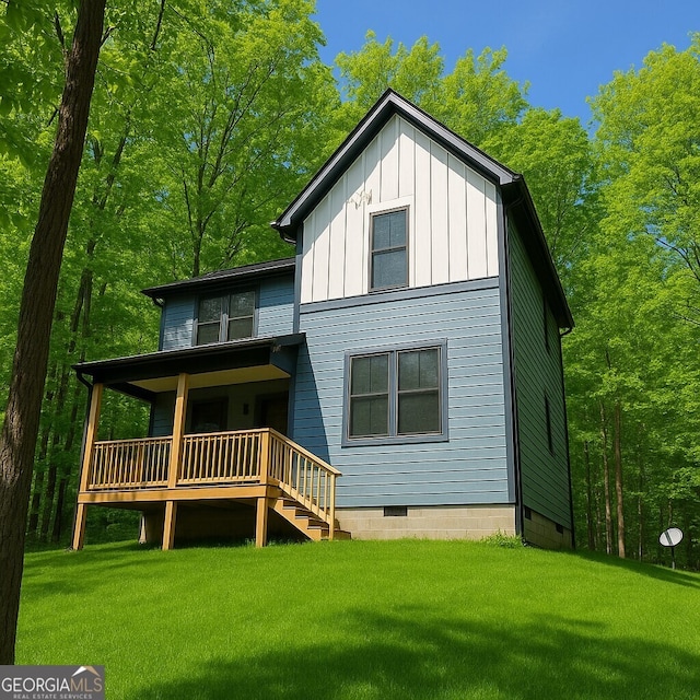 201 Huntington Pl, Dahlonega, GA 30533 - rear view of house with board and batten siding, a lawn, crawl space, and covered porch