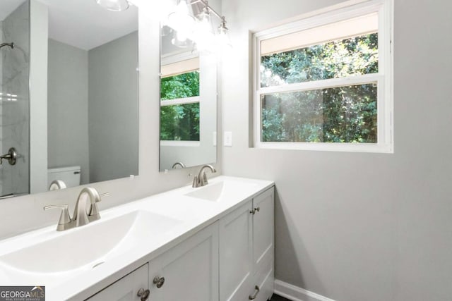 full bathroom with toilet, a sink, and plenty of natural light