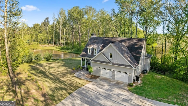 2442 Lower Union Hill Rd, Canton, GA 30115 - view of front of house featuring board and batten siding, a water view, concrete driveway, and a front yard