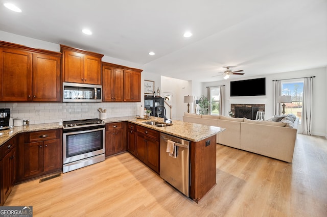 2442 Lower Union Hill Rd, Canton, GA 30115 - kitchen with appliances with stainless steel finishes, a sink, light wood-type flooring, a ceiling fan, and recessed lighting