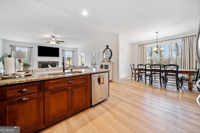 2442 Lower Union Hill Rd, Canton, GA 30115 - kitchen featuring stainless steel dishwasher, a fireplace, light wood finished floors, ceiling fan, and healthy amount of natural light