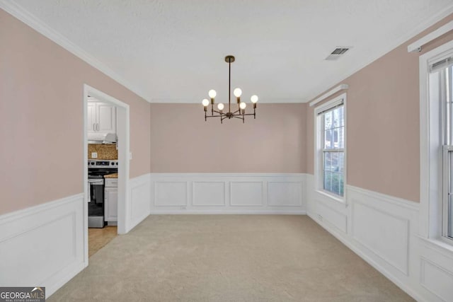 2983 Bancroft Gln NW, Kennesaw, GA 30144 - unfurnished dining area with a chandelier, wainscoting, crown molding, light colored carpet, and a decorative wall
