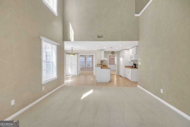 2983 Bancroft Gln NW, Kennesaw, GA 30144 - unfurnished living room with light colored carpet and a towering ceiling