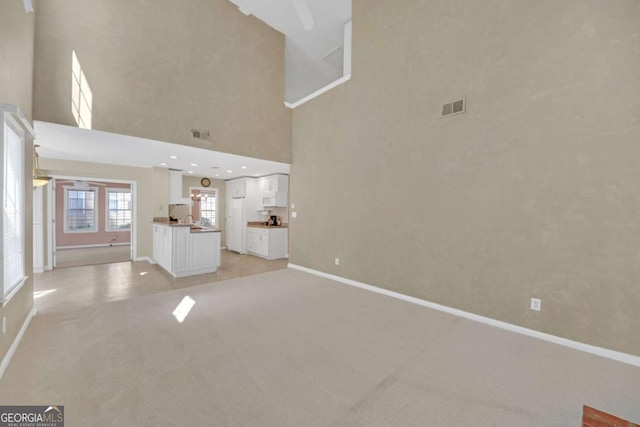 2983 Bancroft Gln NW, Kennesaw, GA 30144 - unfurnished living room featuring light colored carpet and a towering ceiling