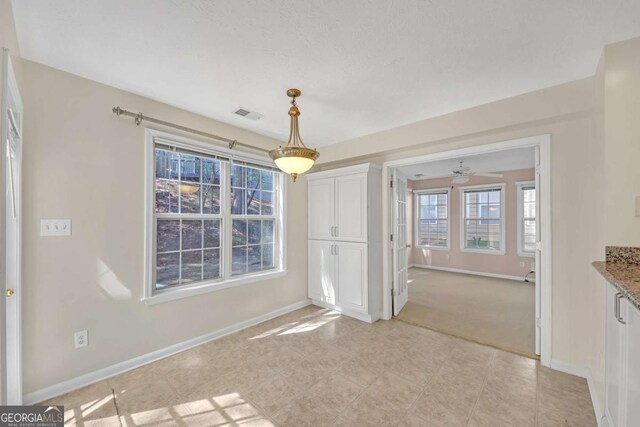 2983 Bancroft Gln NW, Kennesaw, GA 30144 - unfurnished dining area with baseboards and ceiling fan
