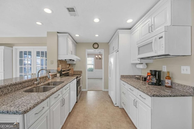 2983 Bancroft Gln NW, Kennesaw, GA 30144 - kitchen with white appliances, white cabinets, recessed lighting, a peninsula, and light stone countertops