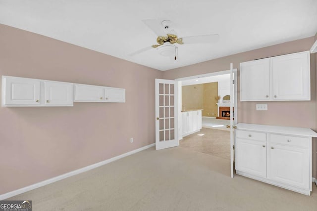 2983 Bancroft Gln NW, Kennesaw, GA 30144 - kitchen featuring white cabinets, ceiling fan, light colored carpet, and light countertops