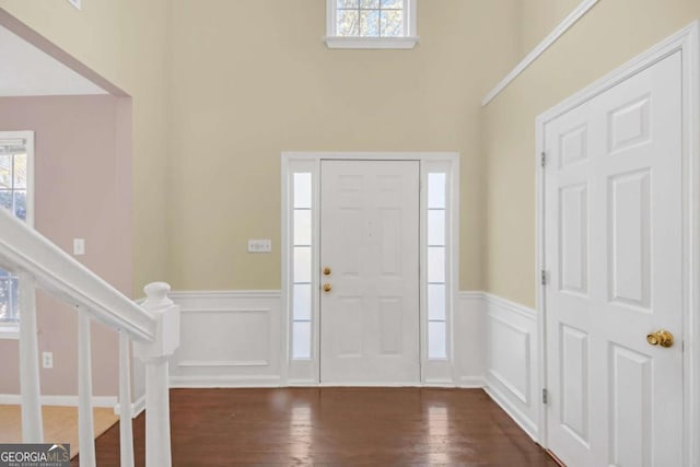 2983 Bancroft Gln NW, Kennesaw, GA 30144 - foyer entrance featuring healthy amount of natural light, wainscoting, a decorative wall, dark wood-style floors, and stairway