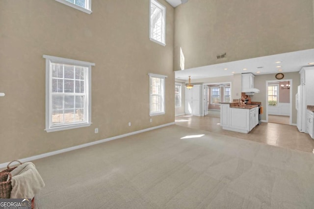 2983 Bancroft Gln NW, Kennesaw, GA 30144 - unfurnished living room featuring light carpet and a towering ceiling
