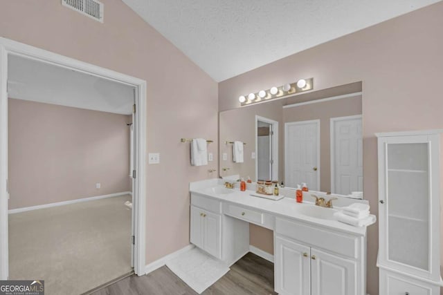 2983 Bancroft Gln NW, Kennesaw, GA 30144 - bathroom with vaulted ceiling, wood finished floors, and double vanity
