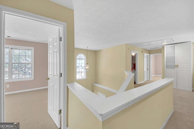 2983 Bancroft Gln NW, Kennesaw, GA 30144 - corridor with light carpet, plenty of natural light, a textured ceiling, and an upstairs landing