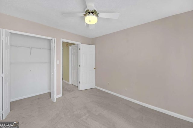2983 Bancroft Gln NW, Kennesaw, GA 30144 - unfurnished bedroom with light carpet, a closet, and a ceiling fan