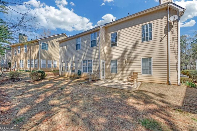 2983 Bancroft Gln NW, Kennesaw, GA 30144 - back of house featuring a patio area and a chimney