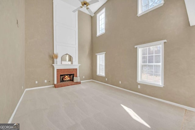 2983 Bancroft Gln NW, Kennesaw, GA 30144 - unfurnished living room featuring ceiling fan, a high ceiling, carpet flooring, and a brick fireplace