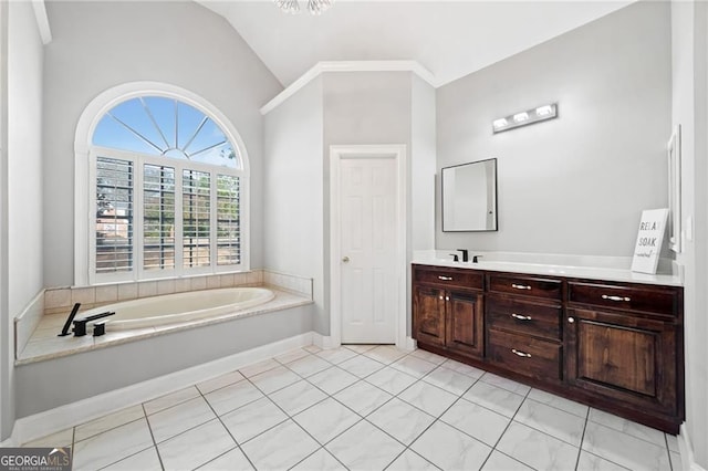 bathroom with lofted ceiling, vanity, and a garden tub