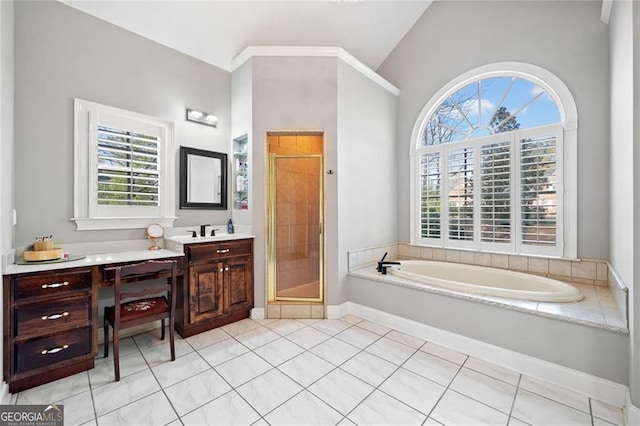 full bathroom featuring a stall shower, healthy amount of natural light, a garden tub, vanity, and lofted ceiling
