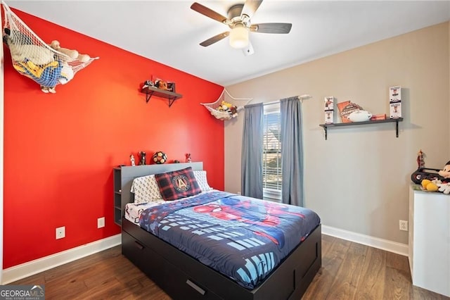 bedroom featuring wood finished floors, baseboards, and a ceiling fan