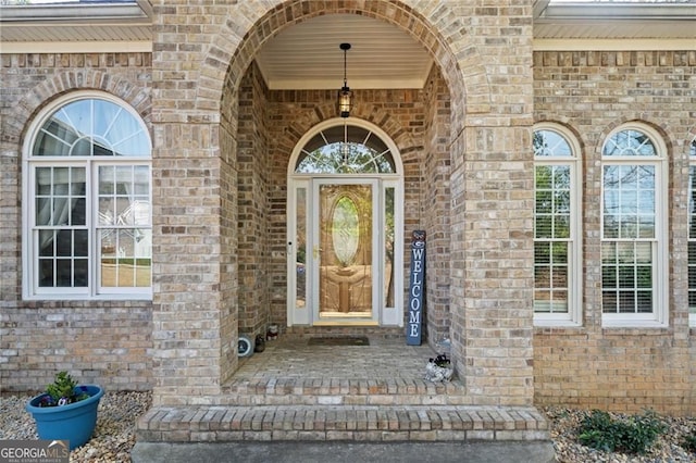 doorway to property with brick siding