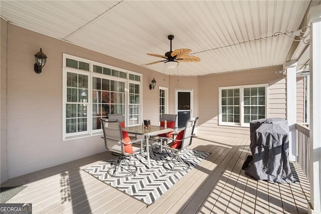 deck featuring outdoor dining space and ceiling fan