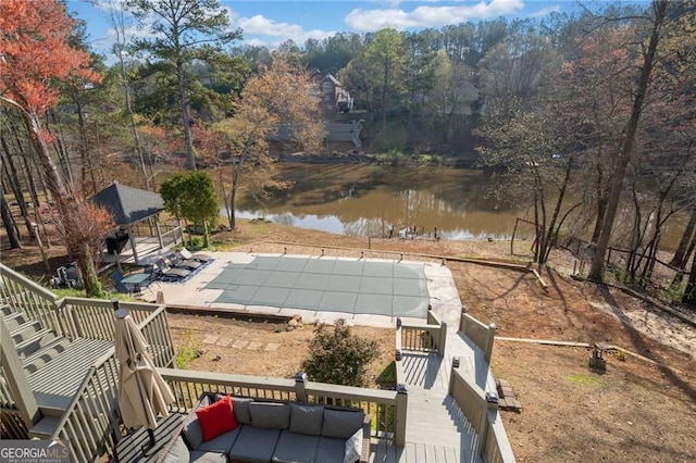 view of swimming pool with a water view, stairway, a patio area, and a covered pool