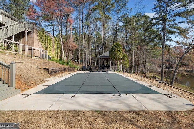 view of swimming pool with a gazebo, a covered pool, and a patio