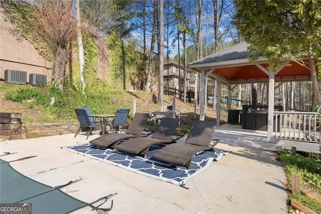 view of patio / terrace with a gazebo, cooling unit, and outdoor dining space