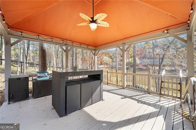 wooden terrace featuring a ceiling fan and an outdoor hangout area