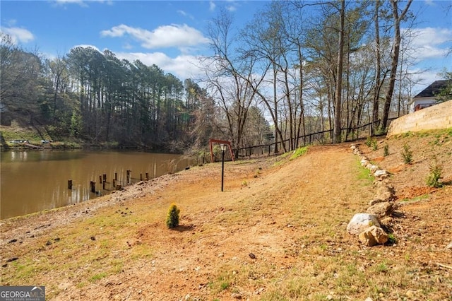 view of yard with a water view and a view of trees