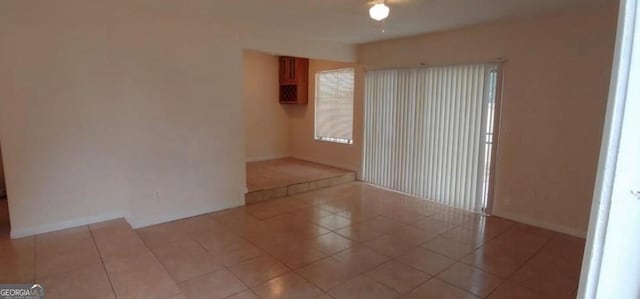 unfurnished room with tile patterned floors