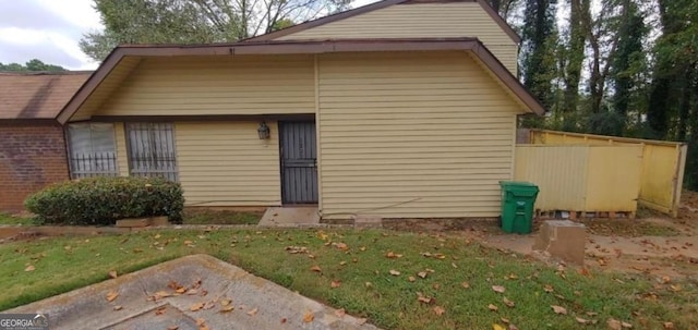 rear view of house featuring a lawn