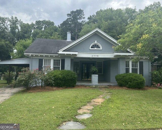 3776 Berkley Dr, Macon, GA 31204 - view of front of home with a front yard, a porch, stucco siding, and driveway