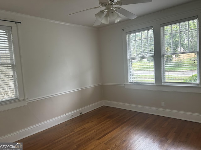 unfurnished room with crown molding, baseboards, ceiling fan, and wood finished floors